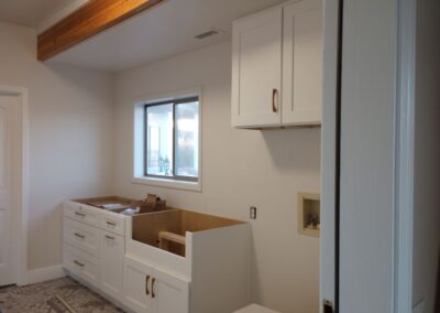 White shaker with farm sink cabinet, laundry
